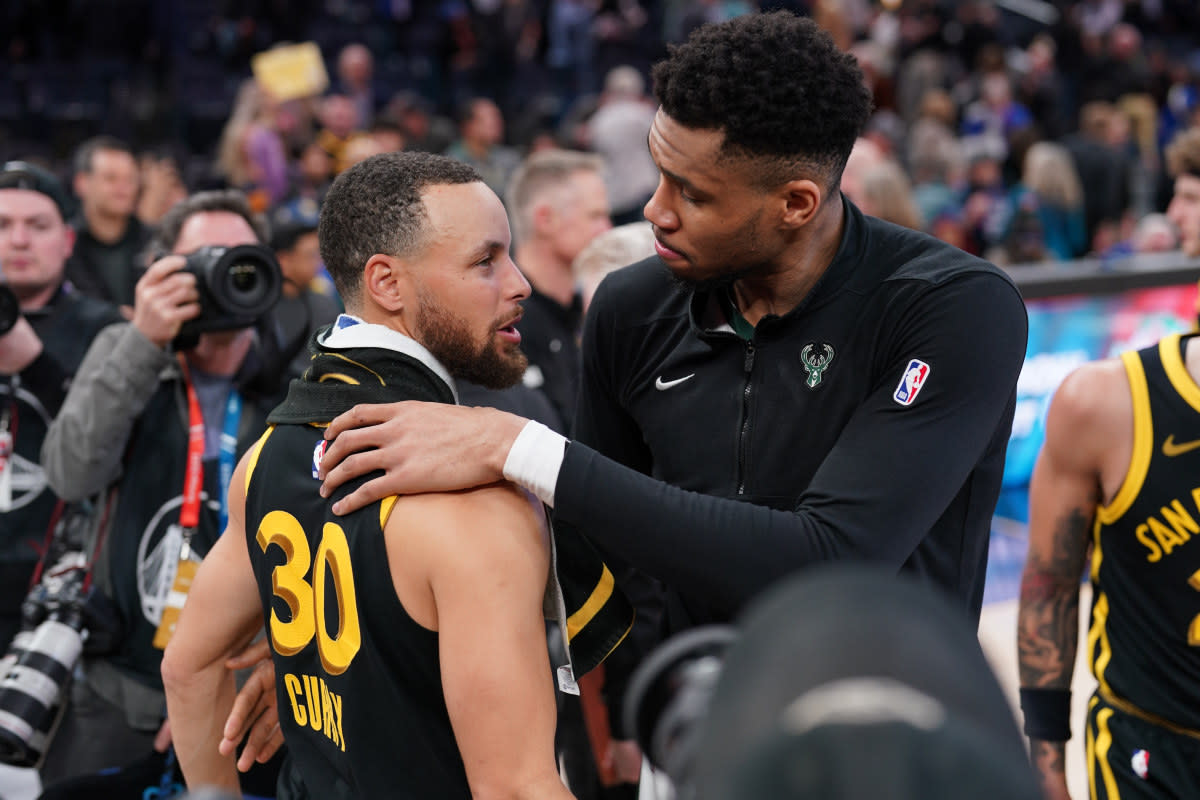 Milwaukee Bucks forward Giannis Antetokounmpo and Golden State Warriors guard Stephen Curry meet after a game.© Cary Edmondson-Imagn Images