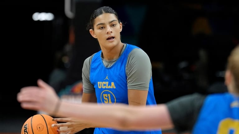 UCLA center Lauren Betts passes the ball during practice prior...