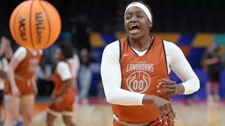 Texas center Kyla Oldacre passes the ball during practice prior...