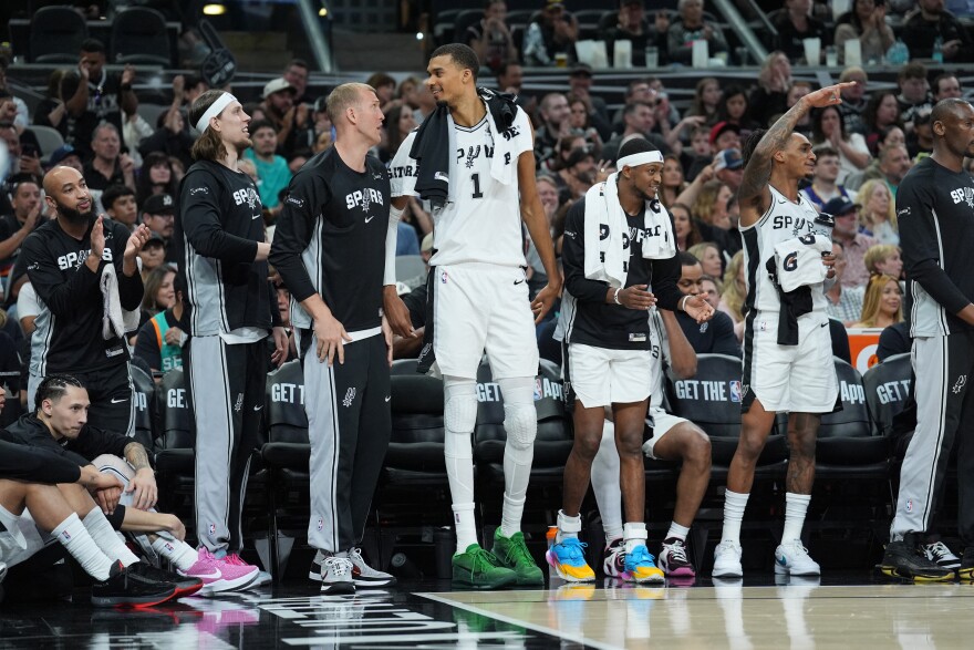 Mar 30, 2026; San Antonio, Texas, USA; San Antonio Spurs forward Kelly Olynyk (8), center Mason Plumlee (45), forward Victor Wembanyama (1), guard De'aaron Fox (4), and guard Devin Vassell (24) celebrate on the bench in the second half against the Chicago Bulls at Frost Bank Center.