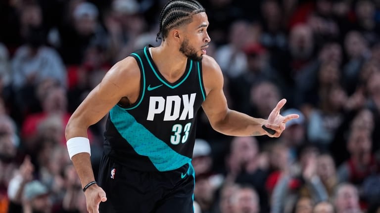 Portland Trail Blazers forward Toumani Camara reacts after making a...