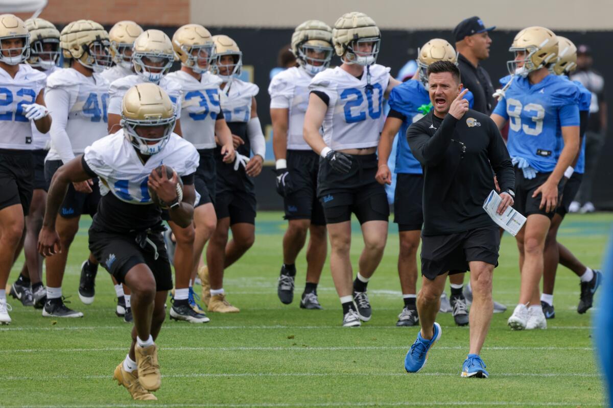 UCLA coach Bob Chesney leads the Bruins through their first spring football practice at Spaulding Field on Thursday.