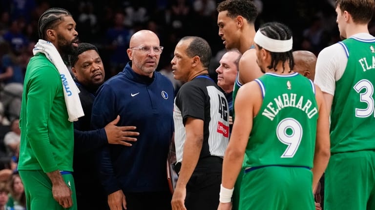 Dallas Mavericks head coach Jason Kidd, center, left, talks to...