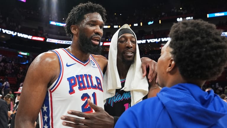 Philadelphia 76ers center Joel Embiid, left, and Miami Heat center...