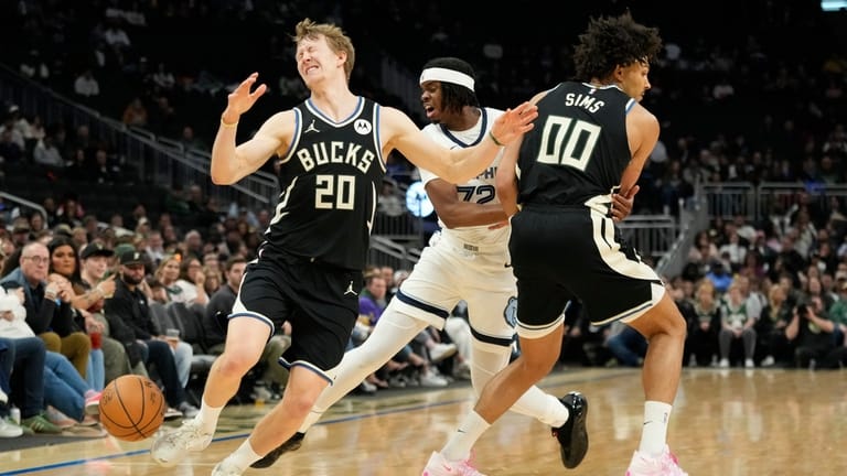 Milwaukee Bucks' AJ Green (20) loses control of the ball...