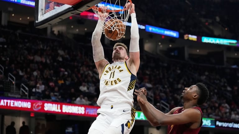 Indiana Pacers center Micah Potter (11) dunks next to Cleveland...