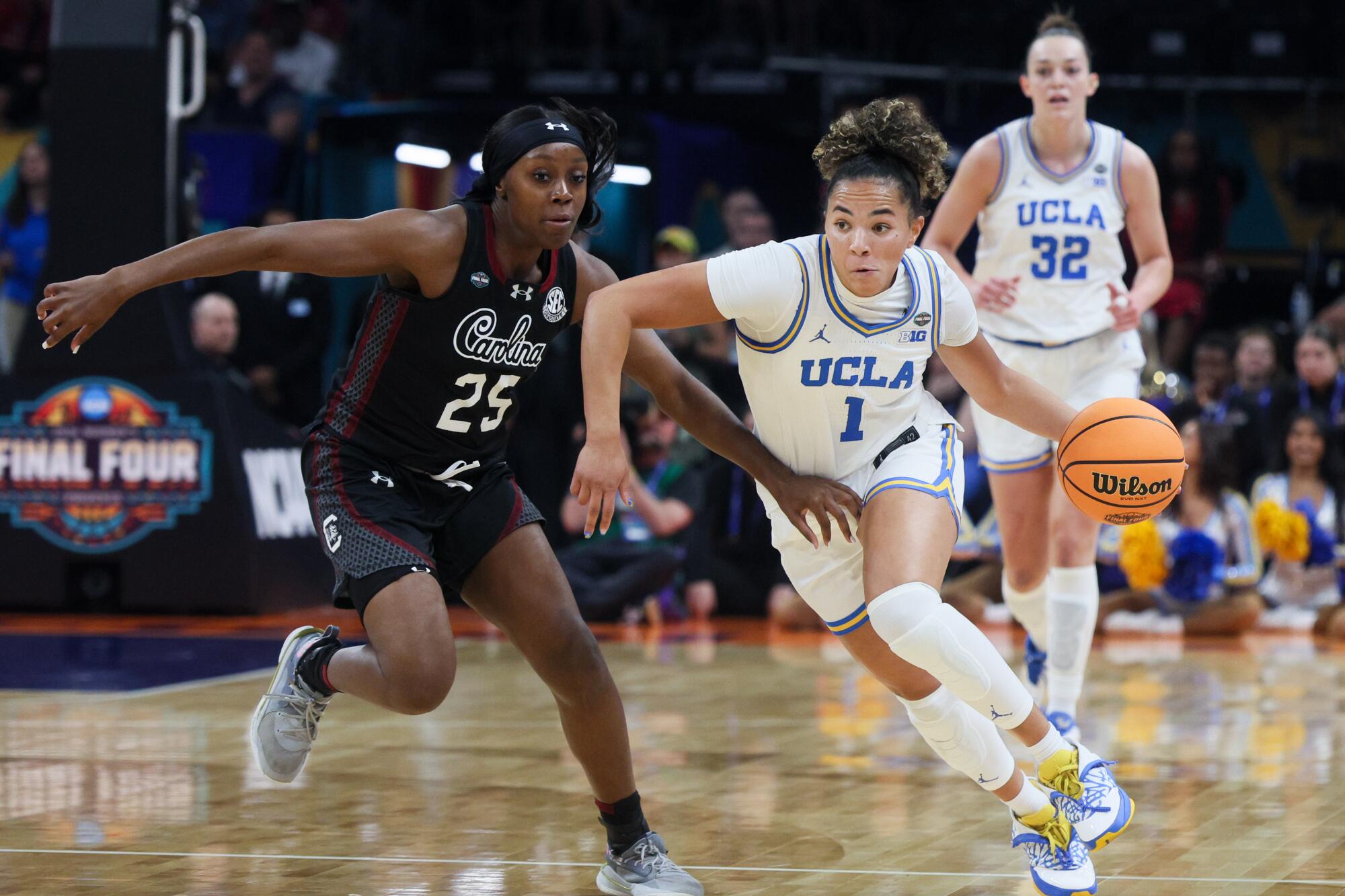 UCLA's Kiki Rice, right, drives around South Carolina's Raven Johnson.