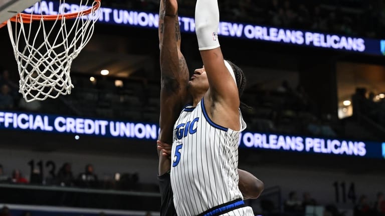 Orlando Magic forward Paolo Banchero (5) dunks in the second...