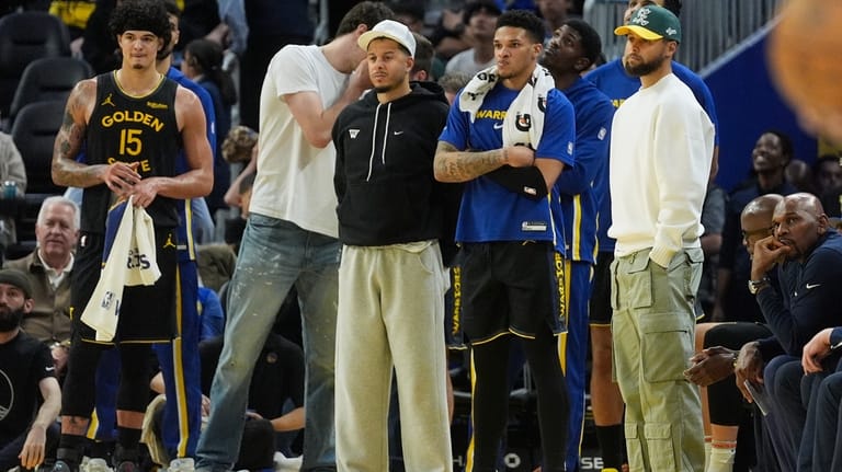 Golden State Warriors forward Gui Santos, from left, reacts from...