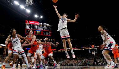 UConn guard Braylon Mullins (24) rebounds against Illinois during the second half of an NCAA college basketball tournament semifinal game at the Final Four, Saturday, April 4, 2026, in Indianapolis. (AP Photo/Abbie Parr)