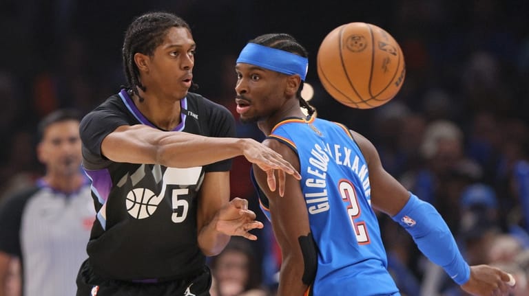 Utah Jazz forward Cody Williams (5) passes the ball away...