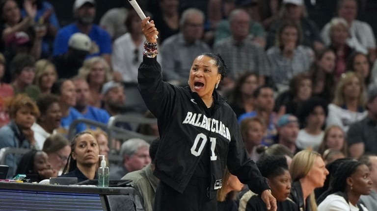 South Carolina head coach Dawn Staley motions towards the court...