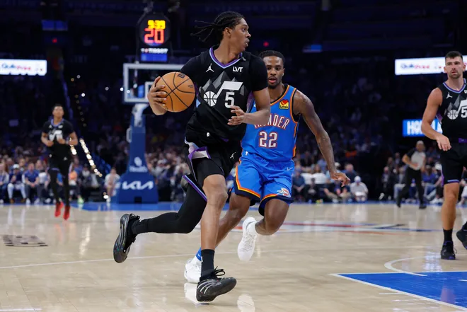 Apr 5, 2026; Oklahoma City, Oklahoma, USA; Utah Jazz forward Cody Williams (5) drives around Oklahoma City Thunder guard Cason Wallace (22) during the second half at Paycom Center. Mandatory Credit: Alonzo Adams-Imagn Images