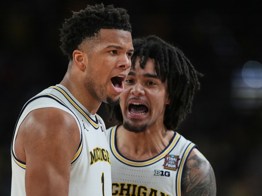 Michigan's Trey McKenney, left, and Elliot Cadeau celebrate during the second half of the NCAA college basketball tournament national championship game against UConn at the Final Four, Monday, April 6, 2026, in Indianapolis.
