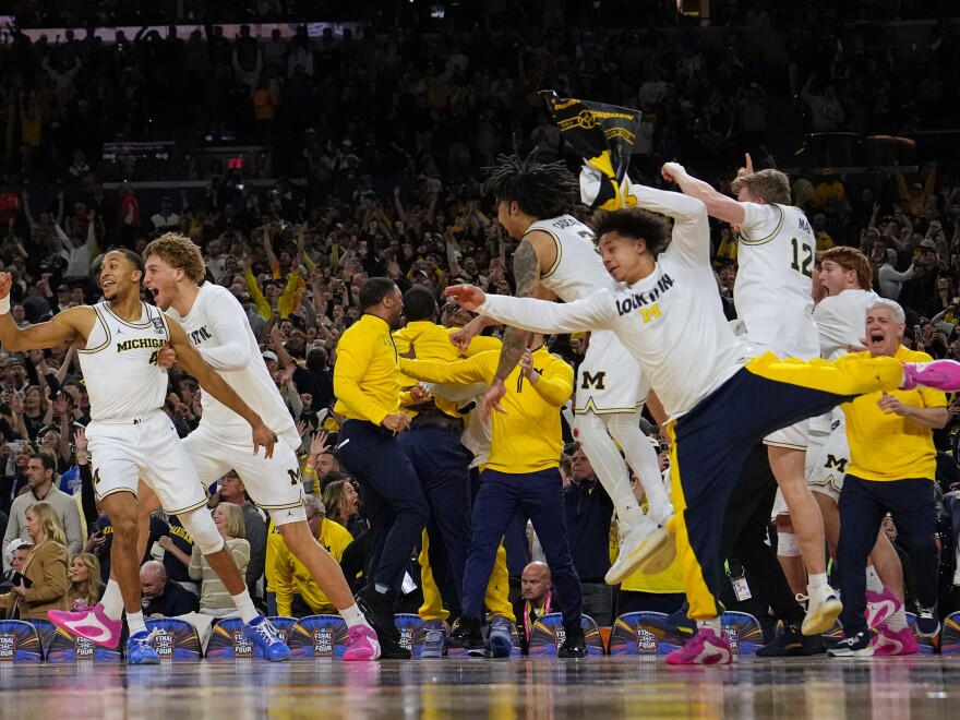 Members of Michigan celebrate after defeating UConn in the NCAA college basketball tournament national championship game at the Final Four, Monday, April 6, 2026, in Indianapolis.