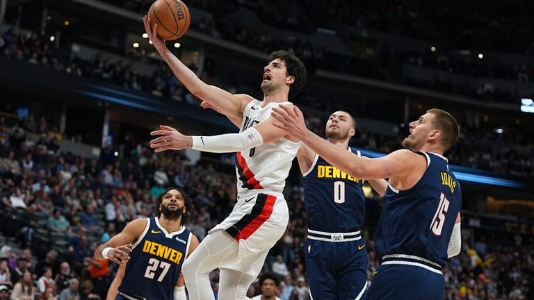 Portland Trail Blazers forward Deni Avdija, front left, drives to...