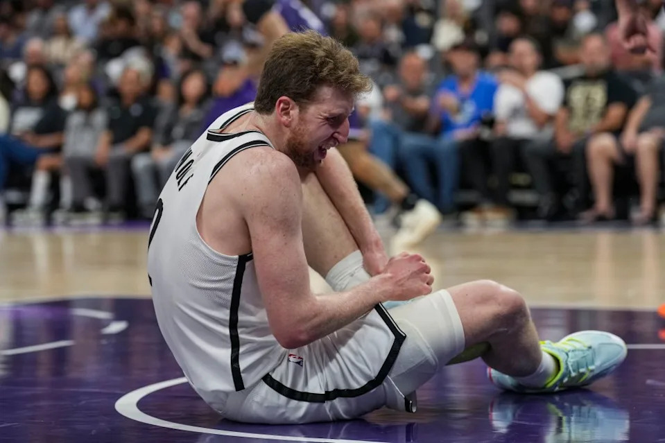 Nets forward Danny Wolf (2) grabs his ankle in pain during the second quarter against the Sacramento Kings at Golden 1 Center. Justine Willard-Imagn Images
