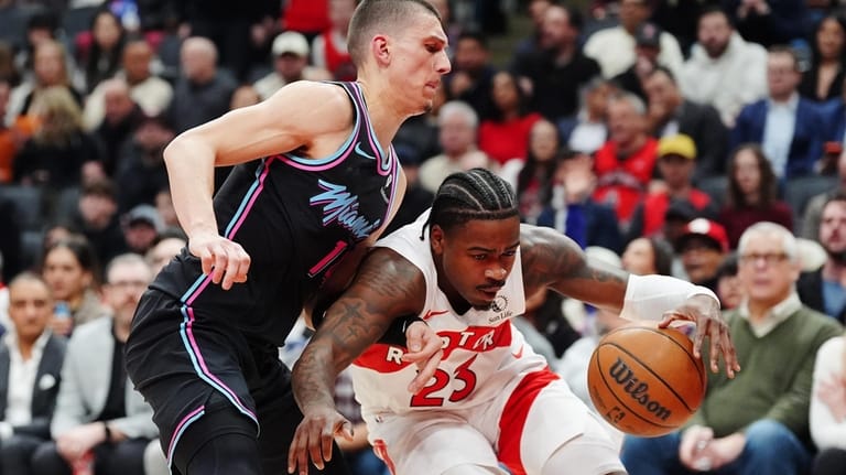 Toronto Raptors' Jamal Shead (23) loses the ball as he...