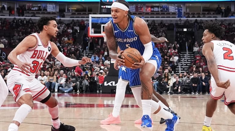 Orlando Magic forward Paolo Banchero (5) drives to the basket...