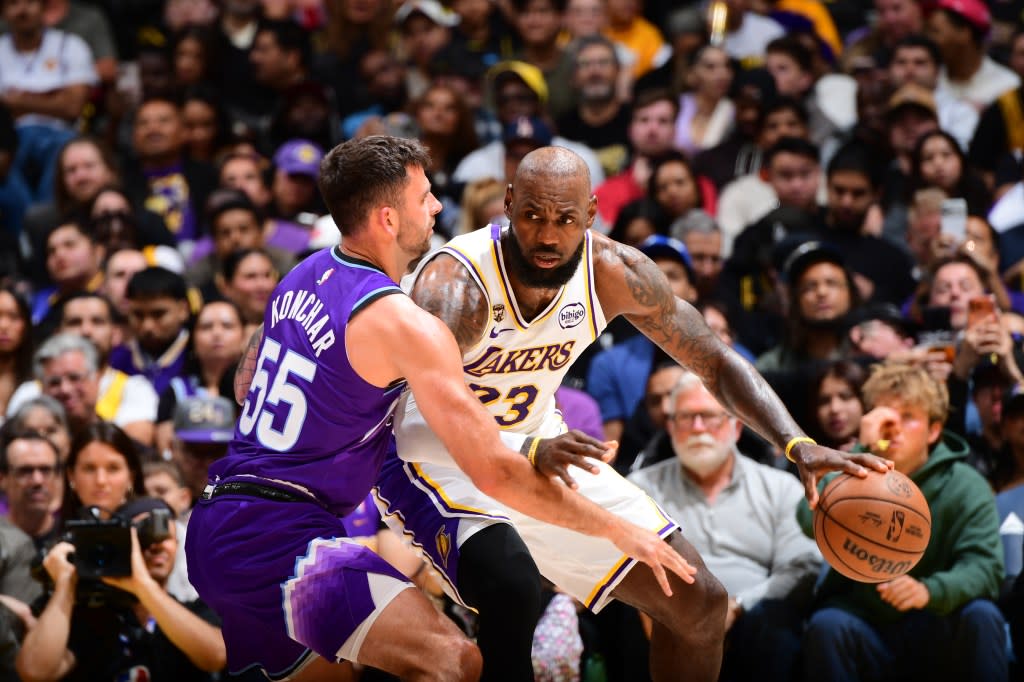 LeBron James back down John Konchar. NBAE via Getty Images