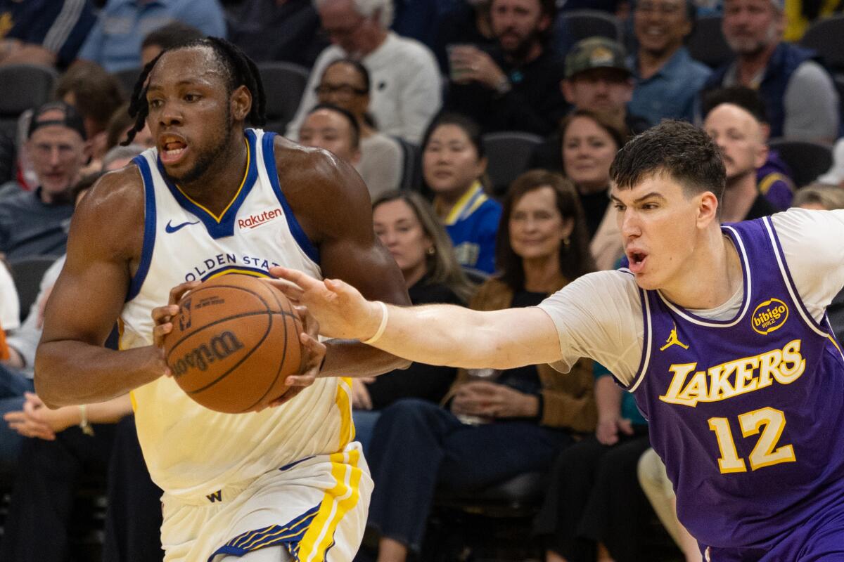 Jake LaRavia reaches in for a steal against Charles Bassey of Golden State in an April 9 game.