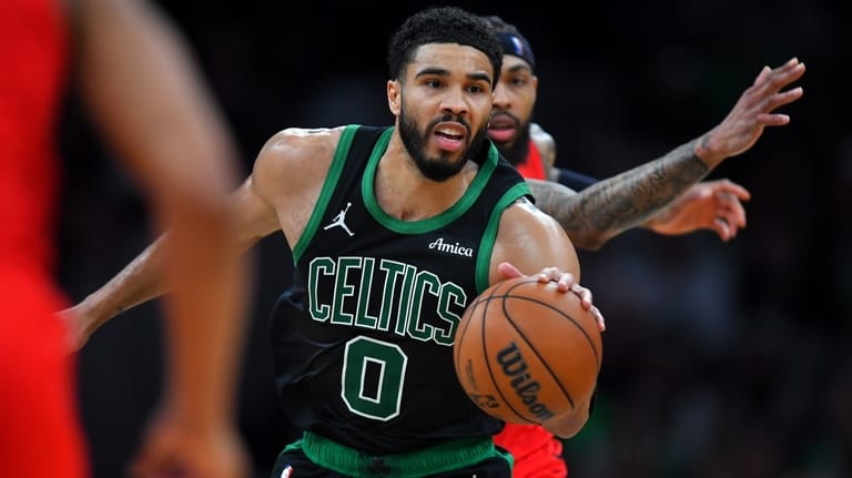 Boston Celtics forward Jayson Tatum (0) drives with the ball...