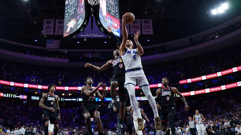 Orlando Magic's Jalen Suggs (4) goes up for a shot...