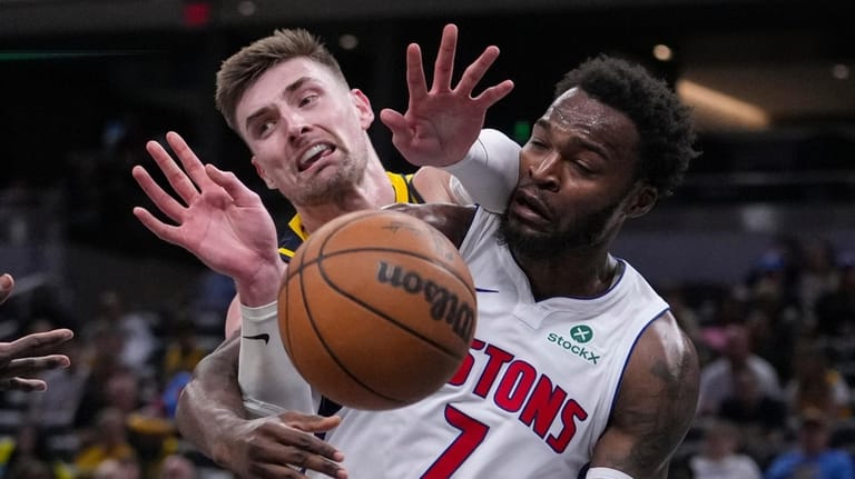 Indiana Pacers center Micah Potter (11) goes over the back...