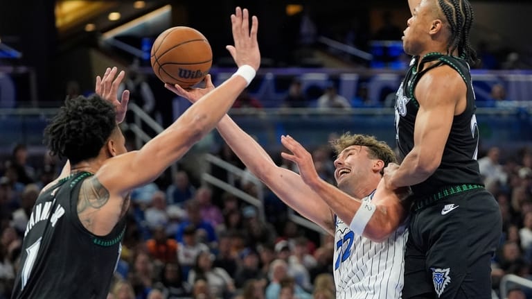 Orlando Magic forward Franz Wagner, center, shoots as he gets...