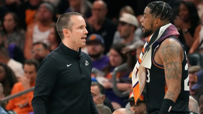 Phoenix Suns head coach Jordan Ott, left, talks with Suns...