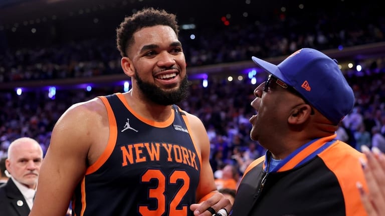 Karl-Anthony Towns of the New York Knicks talks with his father...