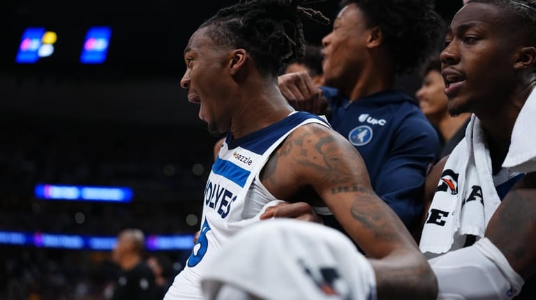 Minnesota Timberwolves guard Bones Hyland (8) celebrates on the bench...