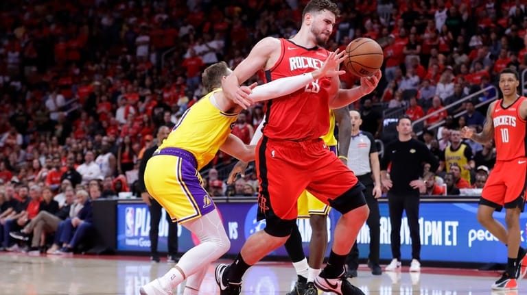 Los Angeles Lakers guard Luke Kennard, left, fouls Houston Rockets...