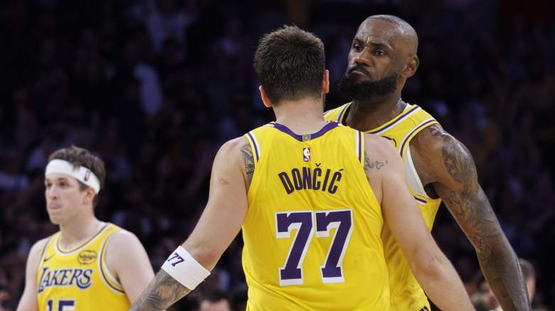 Los Angeles Lakers forward LeBron James and Los Angeles Lakers guard Austin Reaves react with Luka Doncic