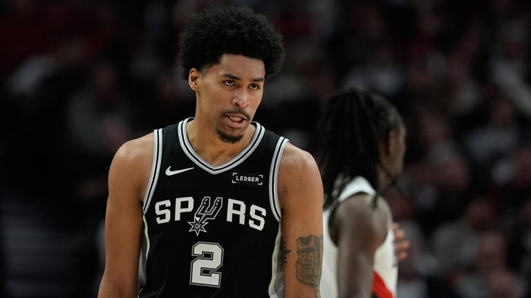 San Antonio Spurs guard Dylan Harper (2) reacts to a...