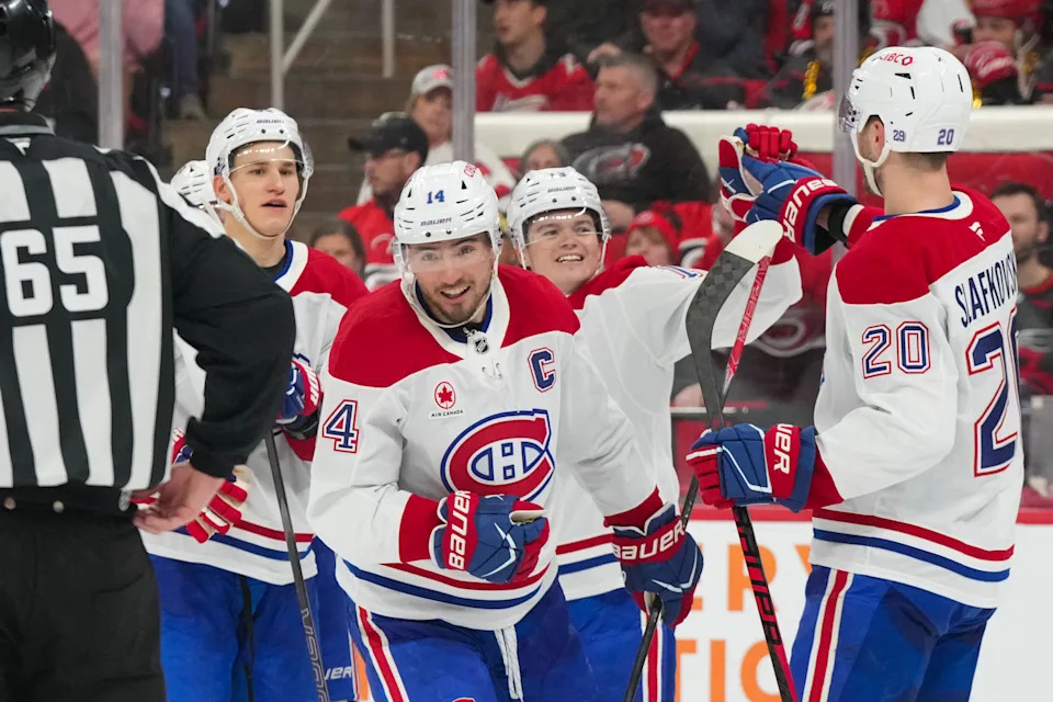Mar 29, 2026; Raleigh, North Carolina, USA;  Montreal Canadiens center Nick Suzuki (14) celebrates his goal with left wing Juraj Slafkovsky (20), right wing Cole Caufield (13) and right wing Ivan Demidov (93) against the Carolina Hurricanes during the third period at Lenovo Center. Mandatory Credit: James Guillory-Imagn Images