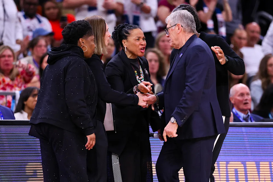 Dawn Staley and Geno Auriemma exchange words in the end-of-game handshake line.