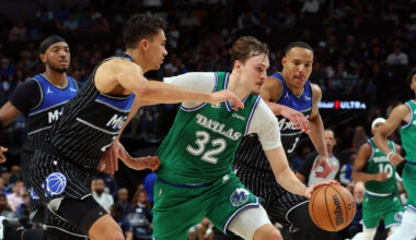Cooper Flagg #32 of the Dallas Mavericks drives to the basket between Orlando Magic's Tristan da Silva and Desmond Bane during a historic 51-point game at American Airlines Center.