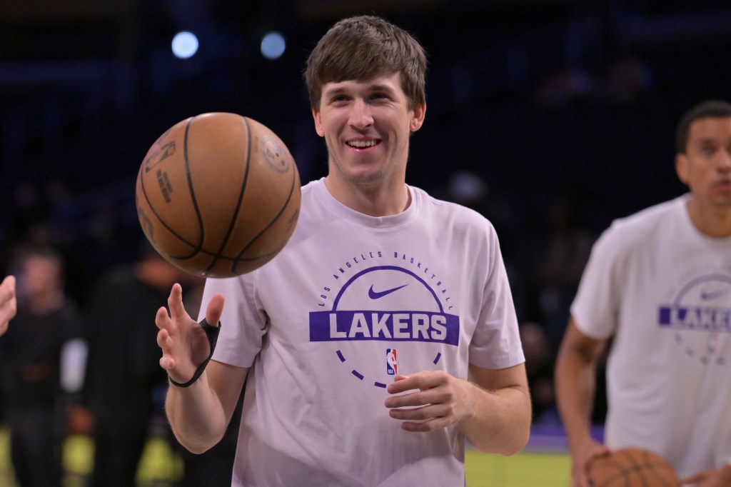 NBA player Austin Reaves of the Los Angeles Lakers dribbles a basketball.