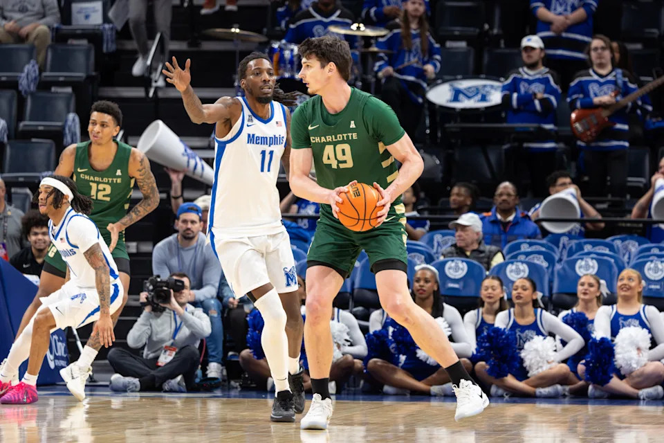 Feb 8, 2026; Memphis, Tennessee, USA; Charlotte 49ers center Anton Bonke (49) handles the ball against Memphis Tigers forward Aaron Bradshaw (11) during the first half at FedExForum. Mandatory Credit: Wesley Hale-Imagn Images