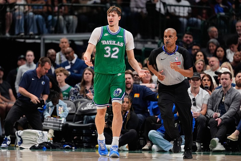 Dallas Mavericks forward Cooper Flagg (32) reacts to play as referee Sean Corbin, right, jogs upcourt in the second half of an NBA basketball game against the Orlando Magic Friday, April 3, 2026, in Dallas. (AP Photo/Tony Gutierrez)