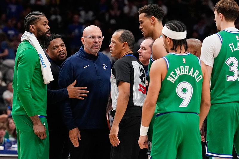 Dallas Mavericks head coach Jason Kidd, center, left, talks to Eric Lewis (42) after Kidd was ejected in the second half of an NBA basketball game against the Orlando Magic Friday, April 3, 2026, in Dallas. (AP Photo/Tony Gutierrez)