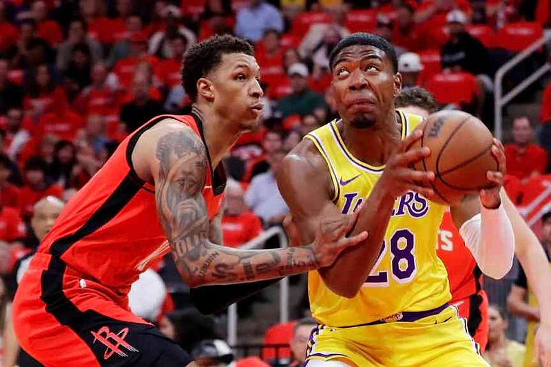 Los Angeles Lakers forward Rui Hachimura, right, looks to shoot while under pressure from Houston Rockets forward Jabari Smith Jr., left, during the first half of Game 3 in a first-round NBA playoffs basketball series Friday April 24, 2026, in Houston. (AP Photo/Michael Wyke)