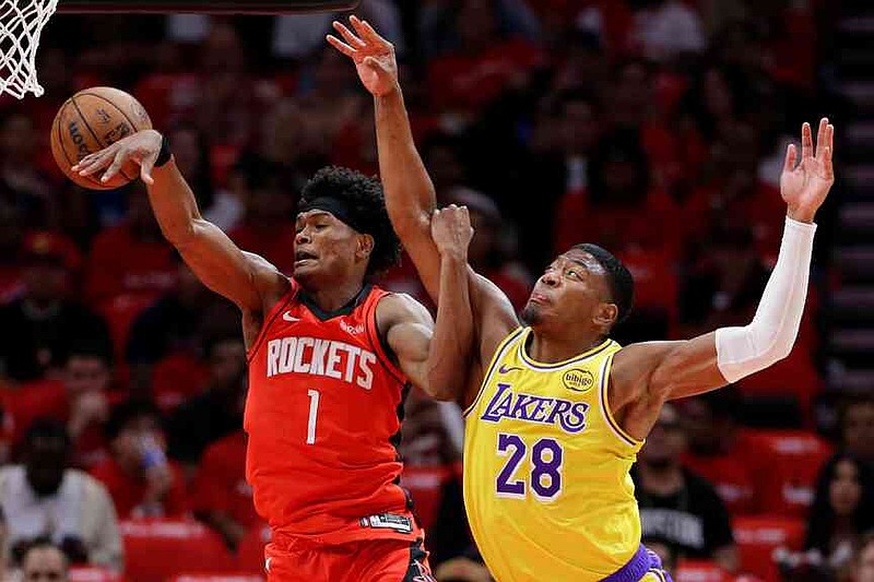 Houston Rockets guard Amen Thompson (1) loses a rebound in front of Los Angeles Lakers forward Rui Hachimura (28) during the first half in Game 3 of a first-round NBA playoffs basketball series Friday April 24, 2026, in Houston. (AP Photo/Michael Wyke)