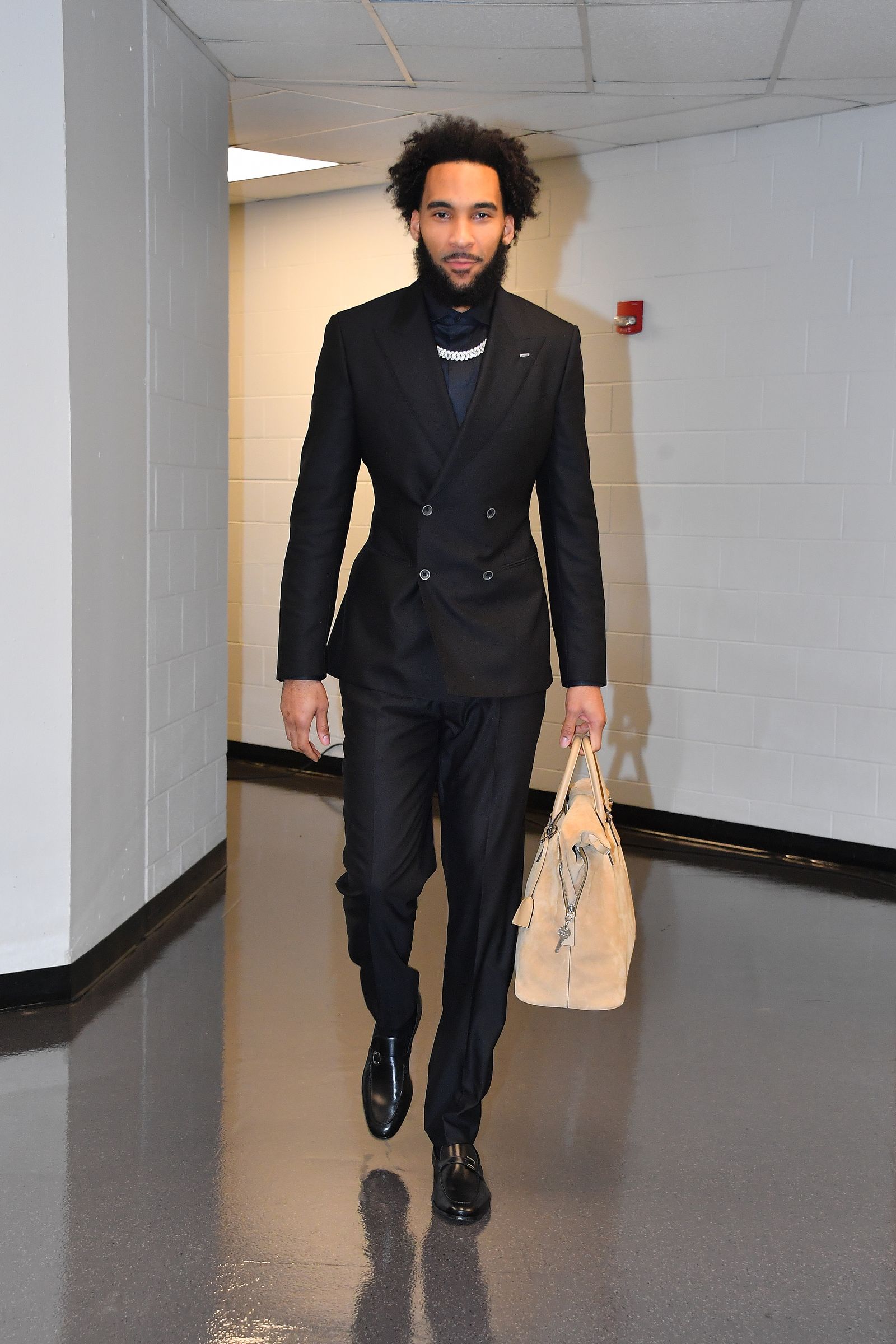 Image may contain Clothing Formal Wear Suit Blazer Coat Jacket Adult Person and Tuxedo