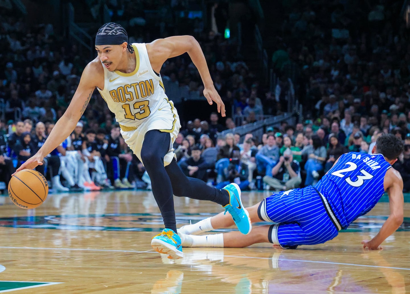 Ron Harper Jr. (left) bursts away from a fallen Magic defender Tristan da Silva during his 27-point effort Sunday.
