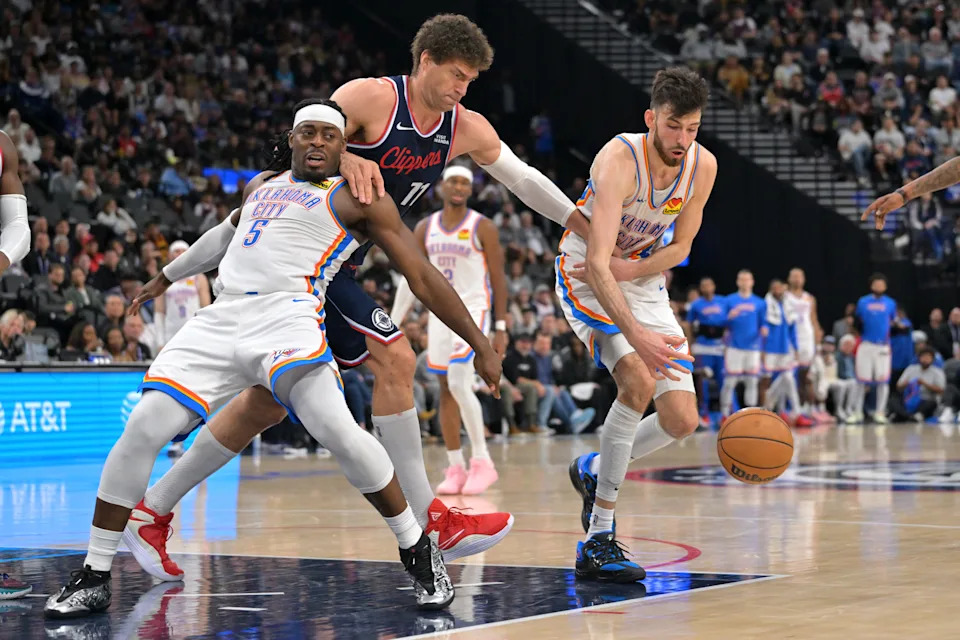 Apr 8, 2026; Inglewood, California, USA; Oklahoma City Thunder guard Luguentz Dort (5), Los Angeles Clippers center Brook Lopez (11) and Oklahoma City Thunder center Chet Holmgren (7) battle for a loose ball in the second half at Intuit Dome. Mandatory Credit: Jayne Kamin-Oncea-Imagn Images