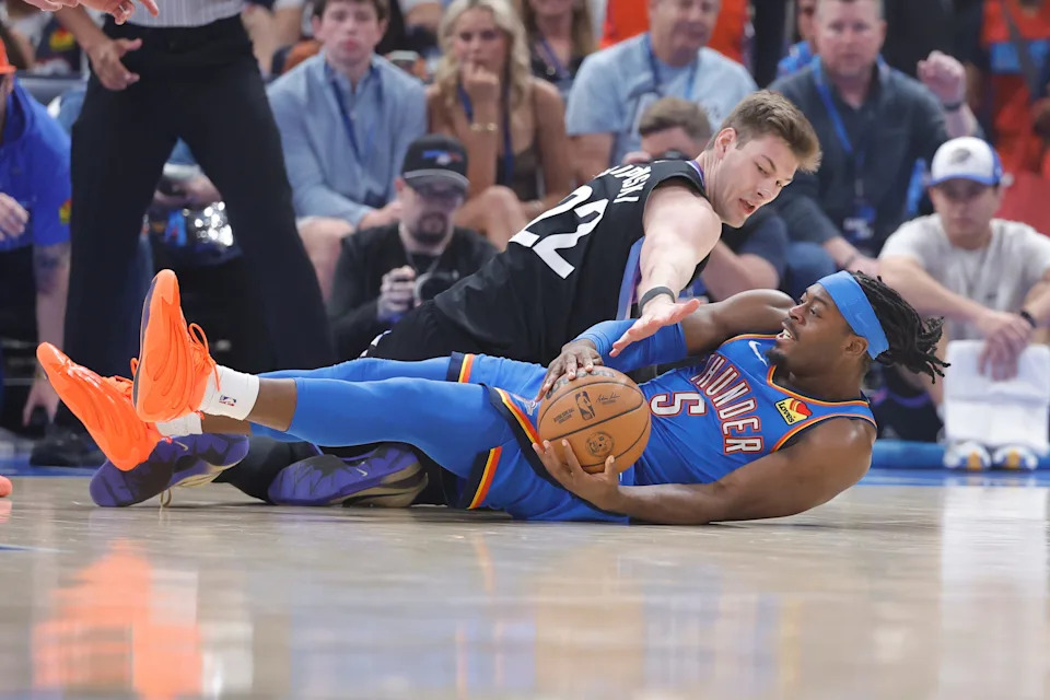 Apr 5, 2026; Oklahoma City, Oklahoma, USA; Utah Jazz forward Kyle Filipowski (22) and Oklahoma City Thunder guard Luguentz Dort (5) fight for a loose ball during the first quarter at Paycom Center. Mandatory Credit: Alonzo Adams-Imagn Images