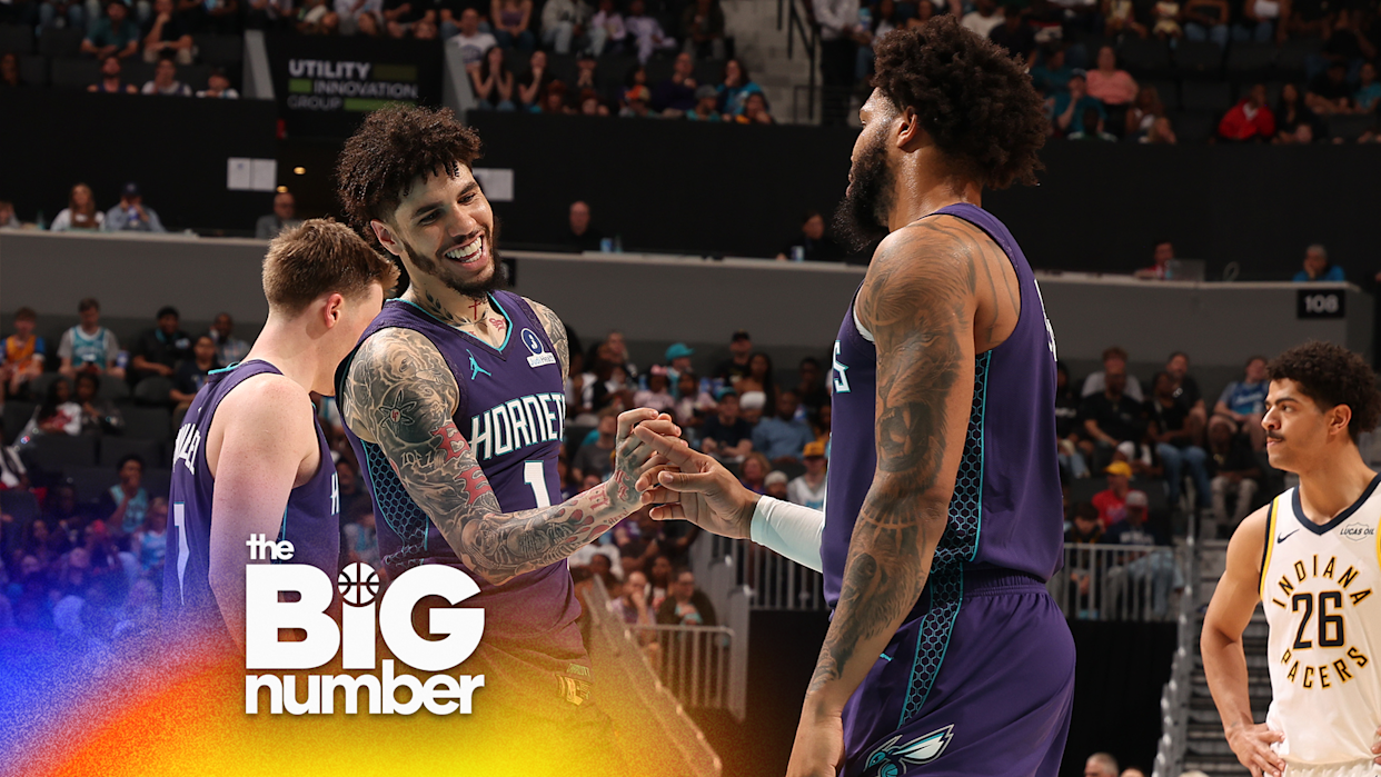 LaMelo Ball #1 of the Charlotte Hornets high fives teammate during the game against the Indiana Pacers on April 3, 2026 at Spectrum Center in Charlotte, North Carolina.