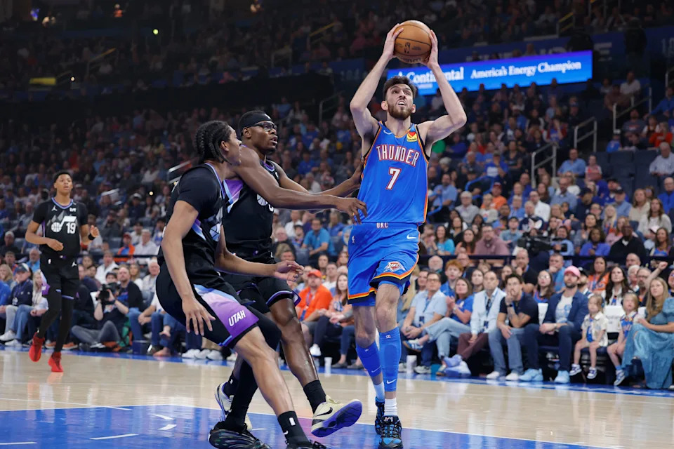 Apr 5, 2026; Oklahoma City, Oklahoma, USA; Oklahoma City Thunder center Chet Holmgren (7) drives to the basket beside Utah Jazz center Oscar Tshiebwe (34) and forward Cody Williams (5) during the first quarter at Paycom Center. Mandatory Credit: Alonzo Adams-Imagn Images
